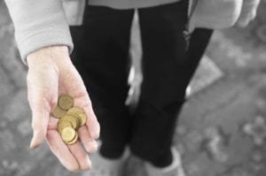 Person holds gold coins