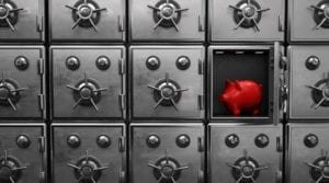 Red piggy bank inside a small vault