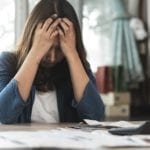 Stressed woman holding her head