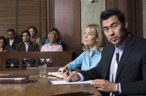 A lawyer sitting with a client in the courtroom