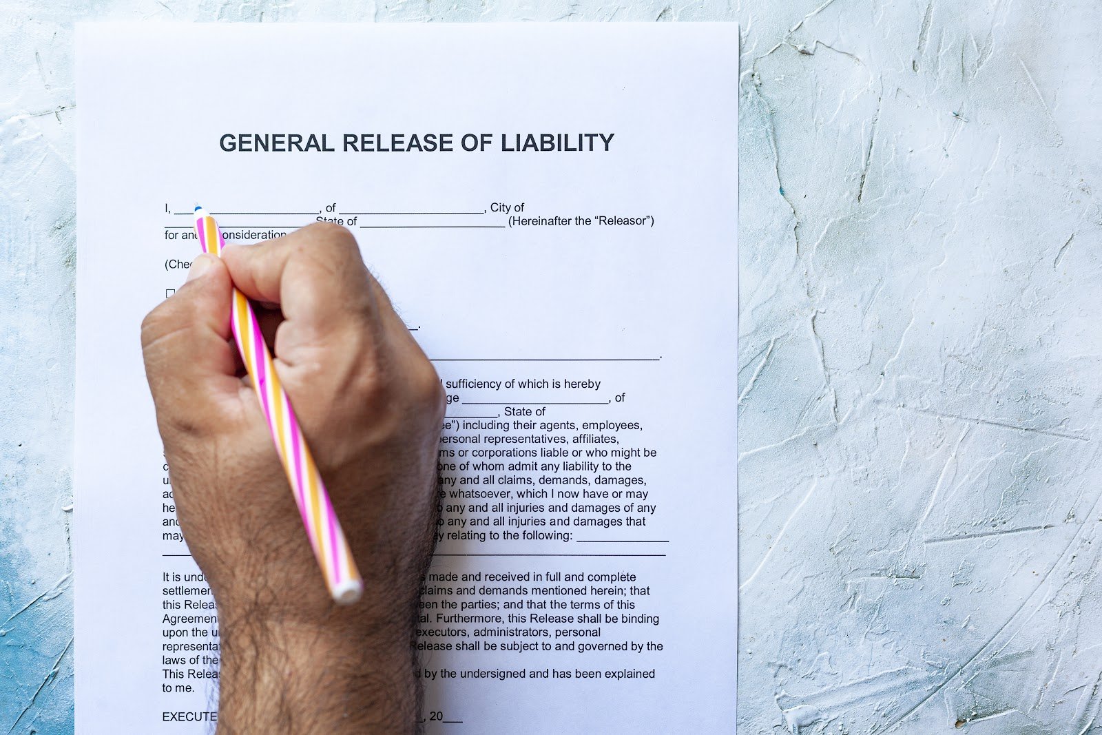 Man signing a General Release of Liability form