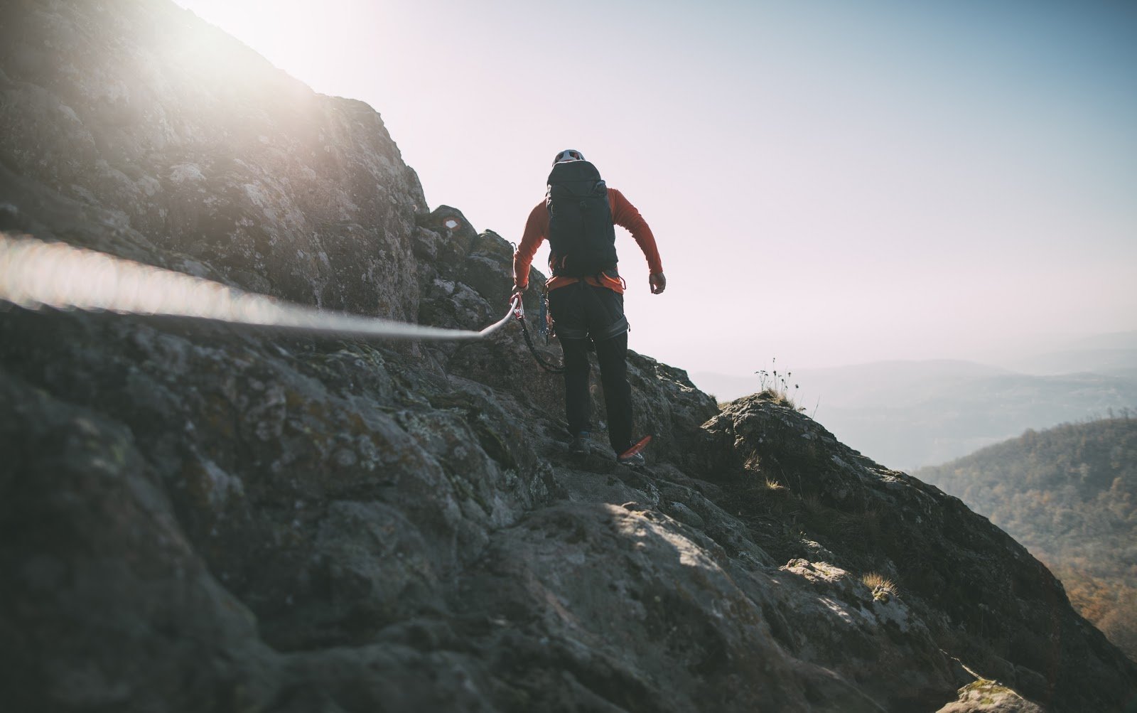 Man hiking on the side of a mountain