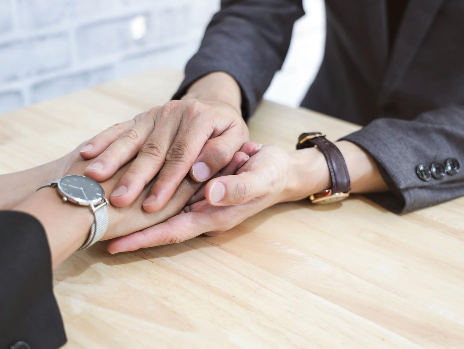Man holding a woman's hands to provide comfort