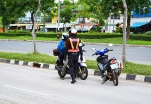 Traffic policeman talking to a motorcycle rider