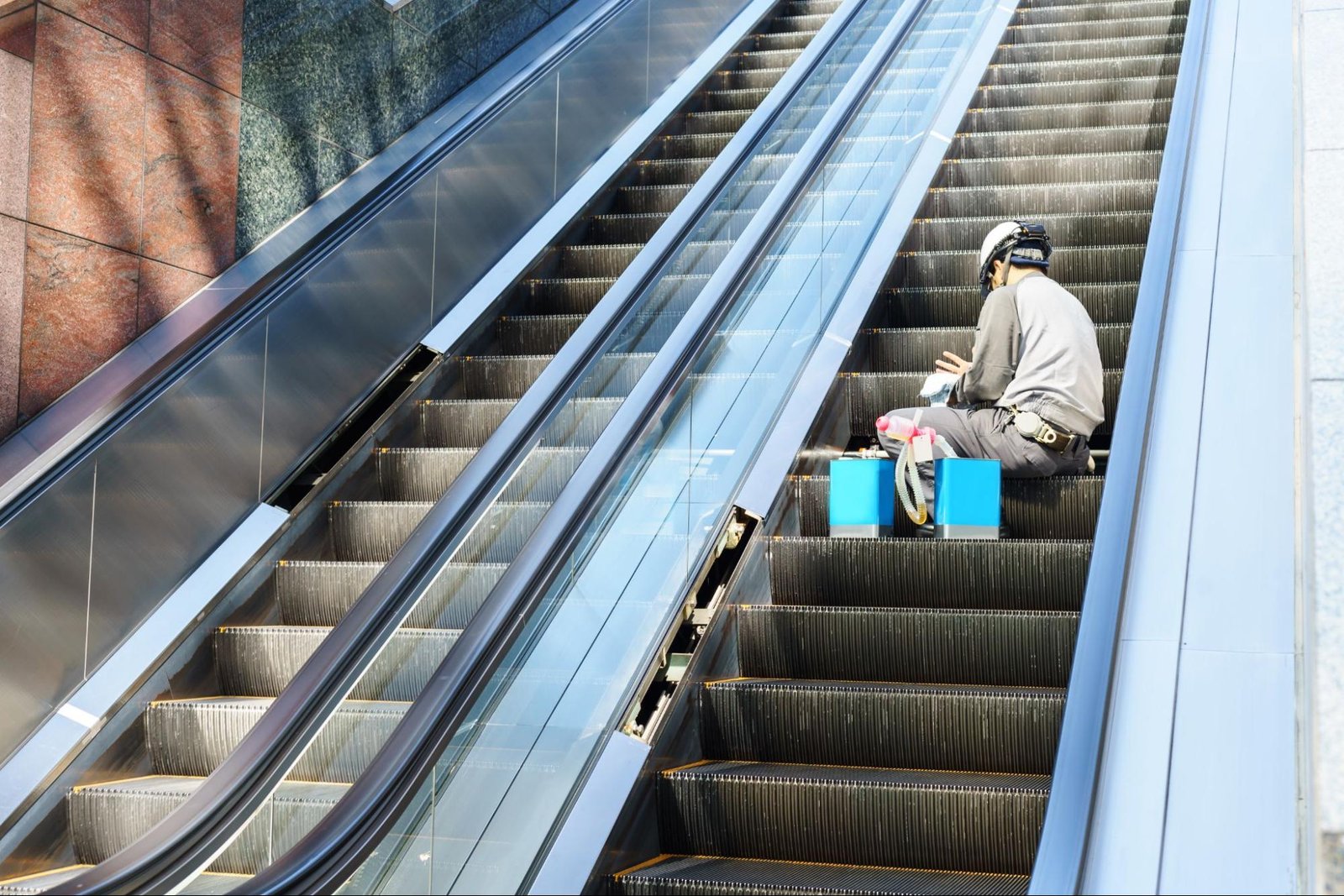 Maintenance person working on an escalator