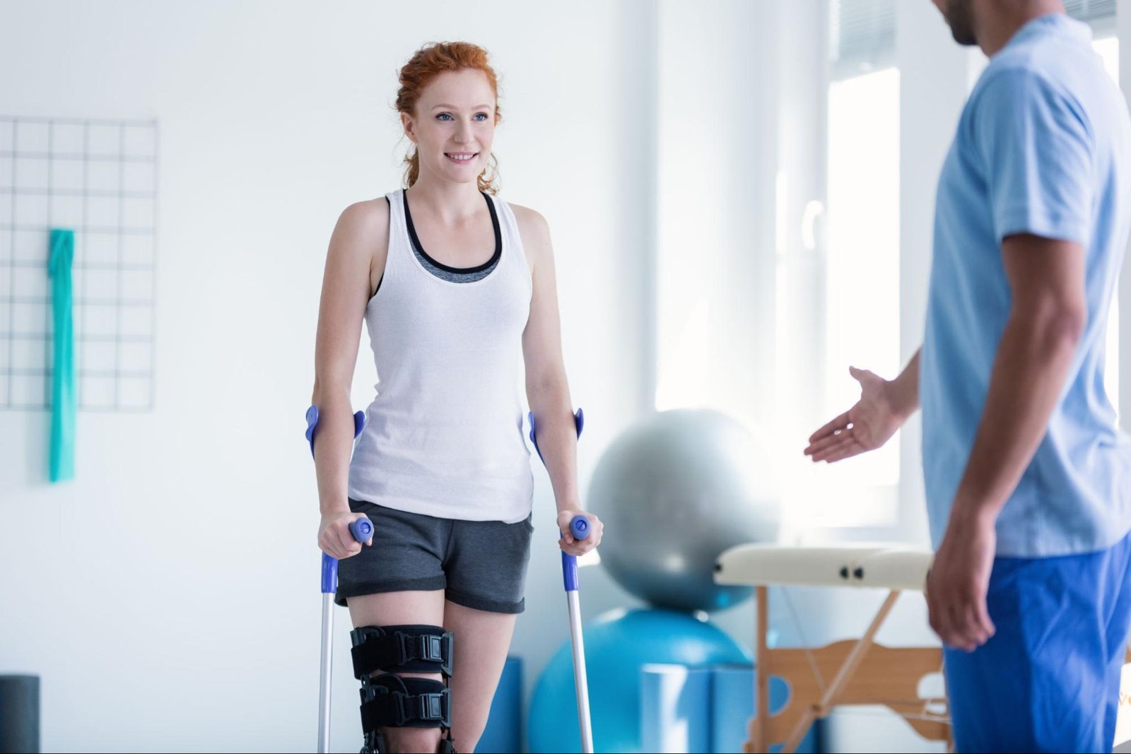 Woman walking with crutches during a physical therapy session
