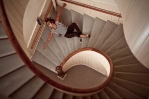 Man falling down a spiral staircase