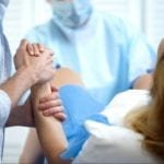 husband supporting his wife during child birth