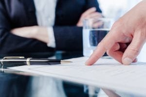 Man pointing to a document on the table during a meeting