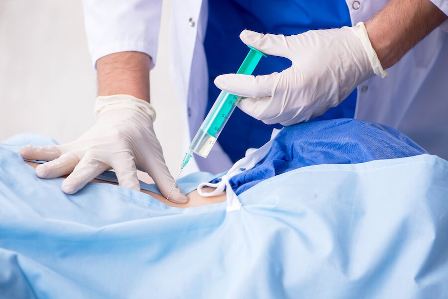 Doctor injecting medication into a patient's back